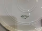 a white plate with a green design on it