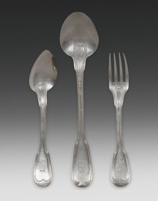 three forks and spoons are sitting next to each other on a table