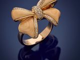 a gold and diamond bow ring