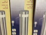 several boxes of different sizes and colors of lamps in a store
