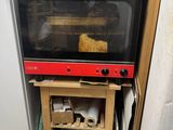 a toaster oven sitting on top of a wooden table