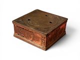a wooden box with carvings on it on a white surface