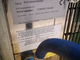 a blue hose attached to the side of a machine