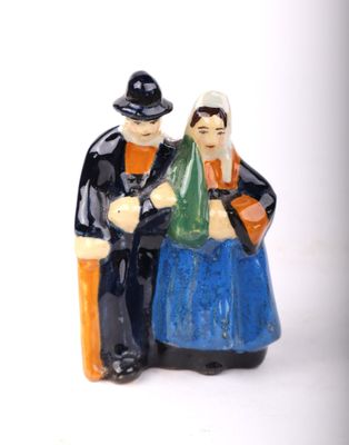 a figurine of a man and a woman sitting on a bench