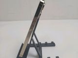 a tablet computer sitting on a stand on a table