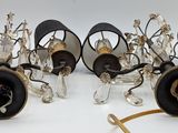 six glass lamps with black shades and gold accents on a white surface
