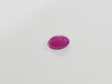 a pink oval shaped stone on a white surface