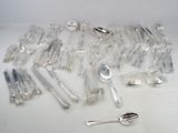 a lot of spoons and forks on the table