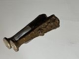 a small metal object on a white surface