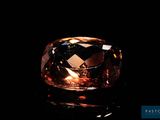 a close up view of a large brown diamond on a black surface