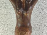 a statue of a mermaid holding a bowl on her head