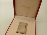 a silver lighter in a red box on a white surface