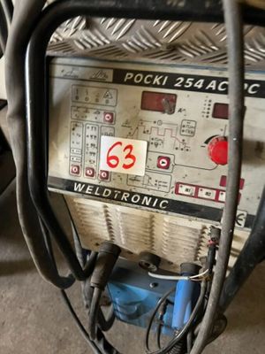 a weldtronic machine that is sitting on the floor