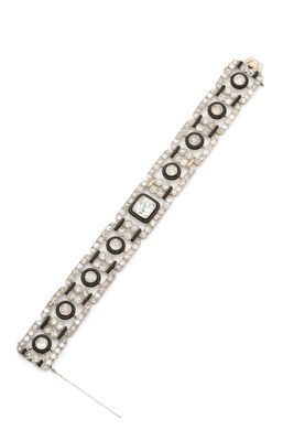 a close up of a silver bracelet with black and white beads