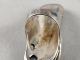 silver plated ring with a hole in the middle of it
