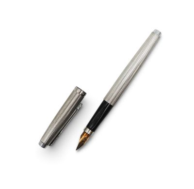 a close up of a pen and a ballpoint pen on a white surface