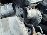 an image of a close up of a car engine with a hose