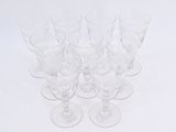 six empty wine glasses sitting on top of a white table