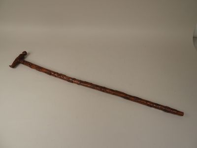 a wooden stick with a hammer on top of it