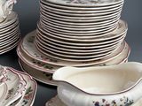 a lot of plates and saucers sitting on a table