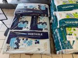several bags of rice sitting on top of a counter in a store
