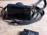 a small camera and a battery on a table