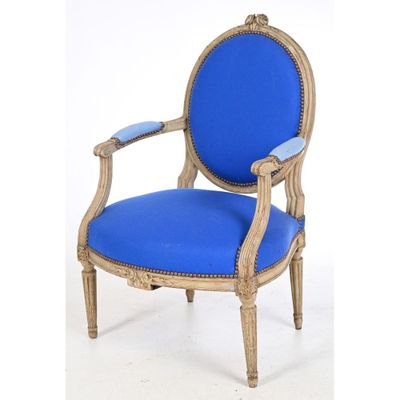 an image of a blue chair with a wooden frame and blue upholstered seat