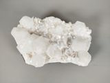 a close up of a piece of rock with white crystals on it