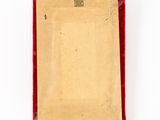 an old picture frame with a red velvet cover and a metal clip