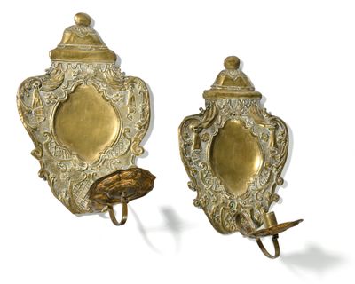 pair of antique brass wall sconces with a bird on one of them