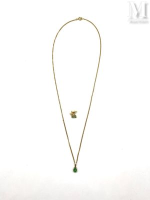 a gold necklace with a green stone pendant and a gold chain