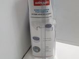 a plastic container with a toothbrush in it on a counter