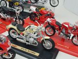 many different types of motorcycles on display in a display case