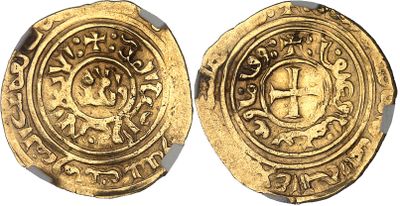 a close up of two gold coins on a white surface