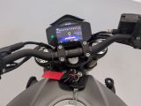 a close up of a motorcycle with a gps device on it ' s handlebar