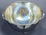 a silver bowl that is sitting on a table