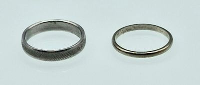 two rings that are sitting on a white surface