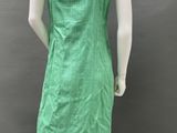 a mannequin wearing a green dress with a white headband