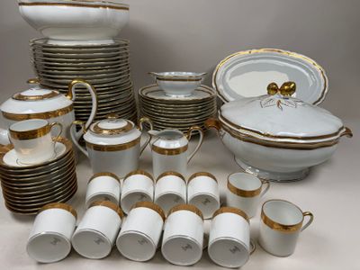 a lot of white and gold dishes and cups on the table