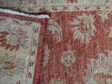 a close up of a red and white rug with a red border