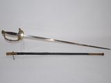 an old sword with a wooden handle on a white surface