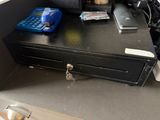 an image of a cash register and a cell phone on a desk