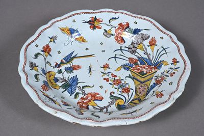 a plate with a bird and flower design on it