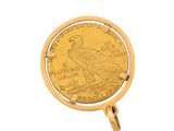 a close up of a gold coin with a bird on it