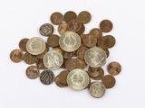 a pile of coins on a white surface