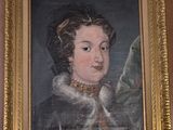painting of a woman in a black dress with a gold frame