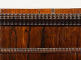 a wooden chest with a metal handle on it