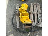 a yellow machine that is sitting on the ground next to a pallet