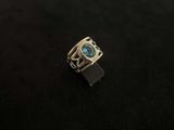 a picture of a ring with a blue stone in it