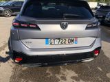 the rear end of a silver car parked in a parking lot